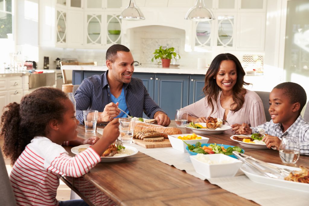 Family of four eating a healthy dinner